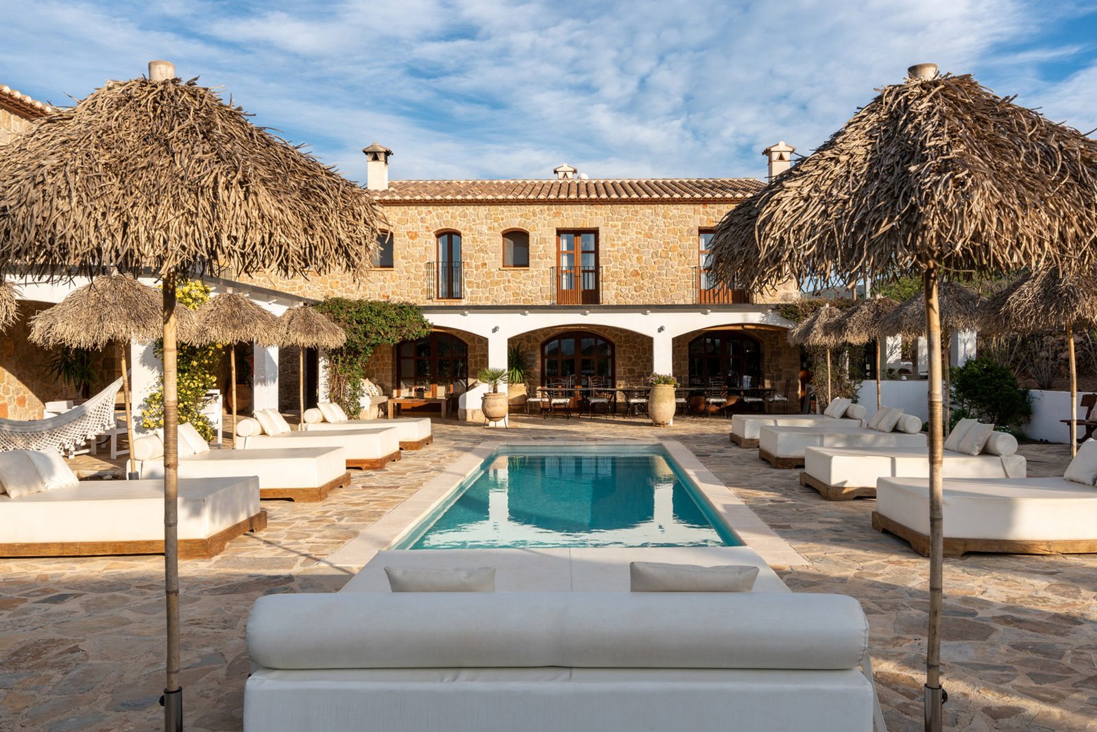 Sun loungers and parasols along the finca pool